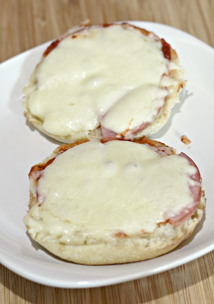 English muffin pizzas baked on white plate