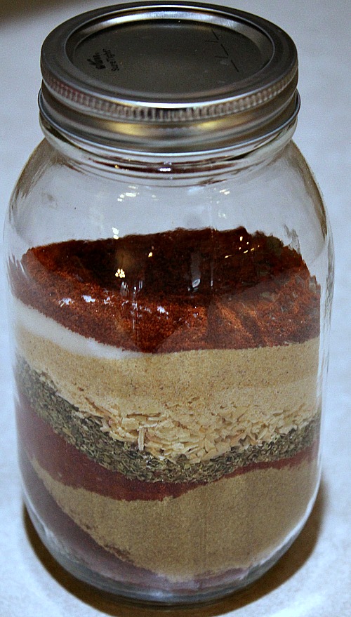 Layered Homemade Taco Seasoning in a mason jar before mixing
