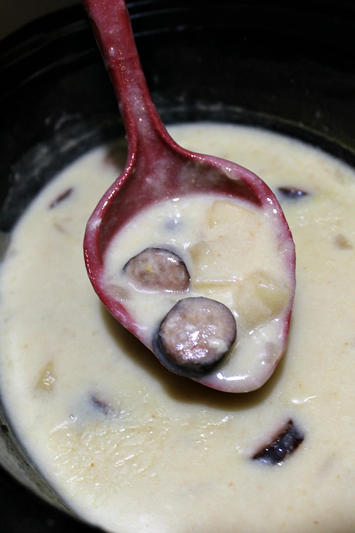 Crockpot Sausage Potato Soup  cooked on a ladle in a crockpot