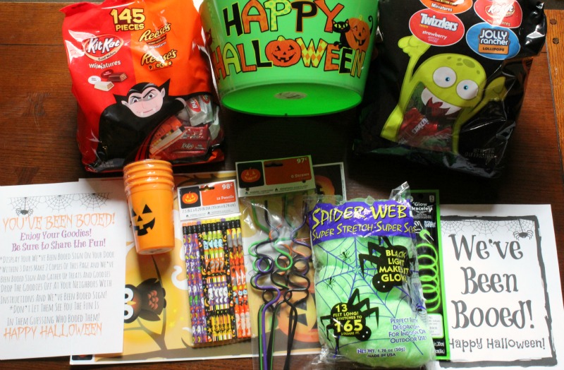 Halloween bucket with candy and hallowen goods with print outs of booed printables 