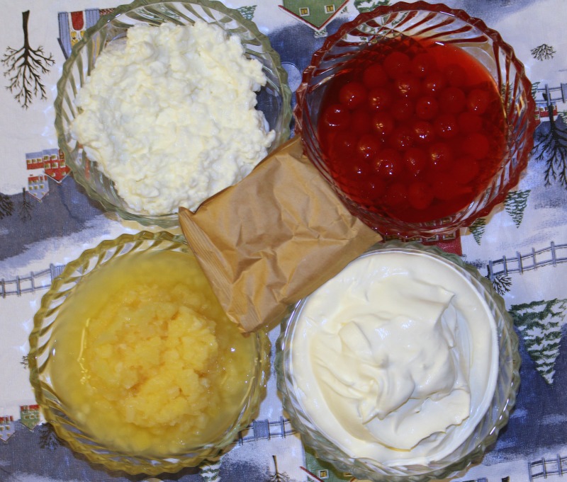 Cherries, crushed pineapple, cool whip, cottage cheese, and cherry jello in bag different bowls