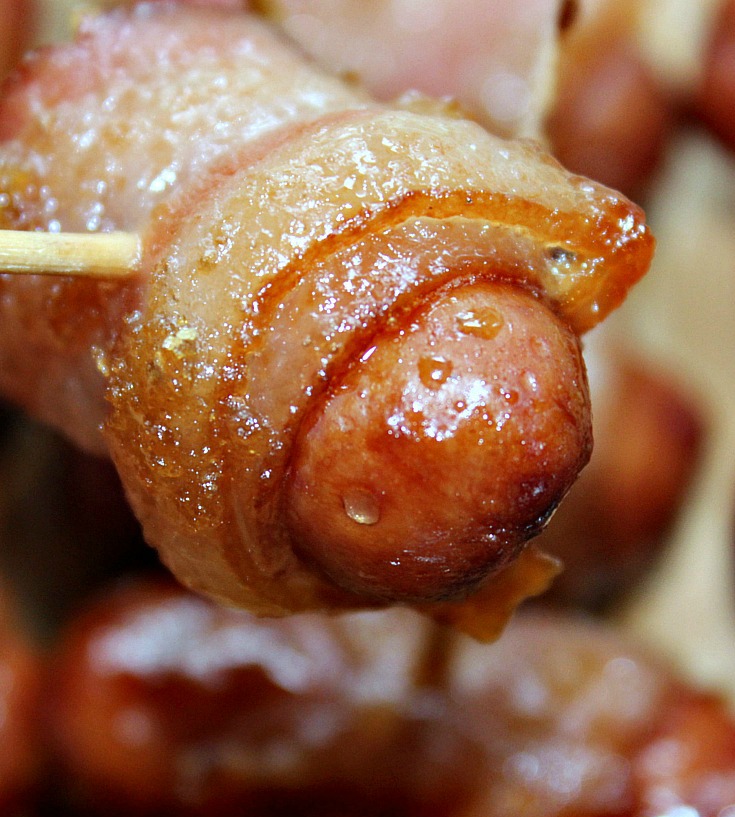 Bacon Wrapped Smokies cooked on a tooth pick. 
