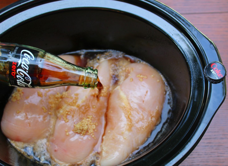 Coke Zero being poured over chicken breasts in crockpot 