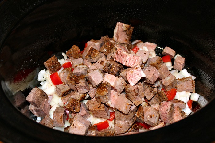 Diced Brisket, onion, and red pepper in bottom of crockpot 