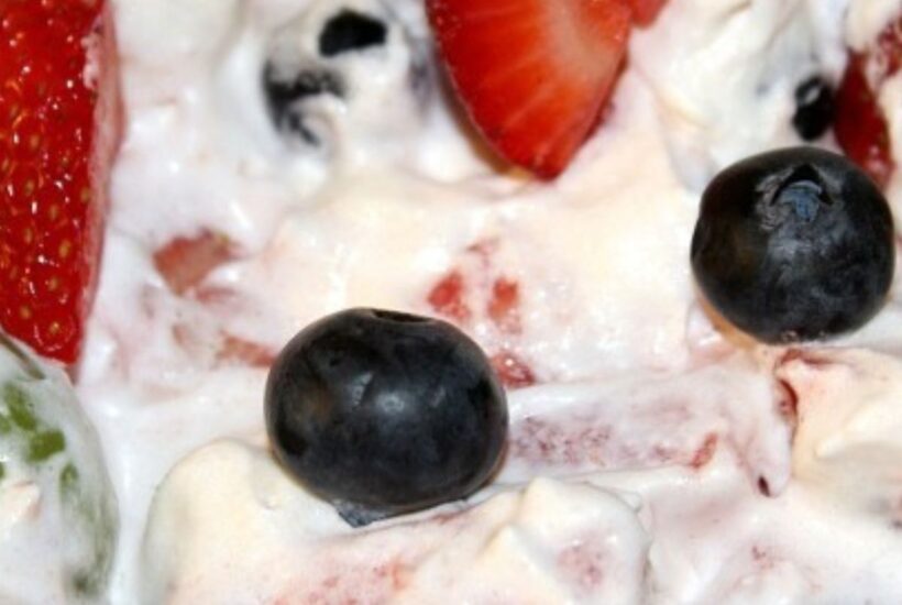 Strawberries blueberries, grapes, and watermelon in whipped topping