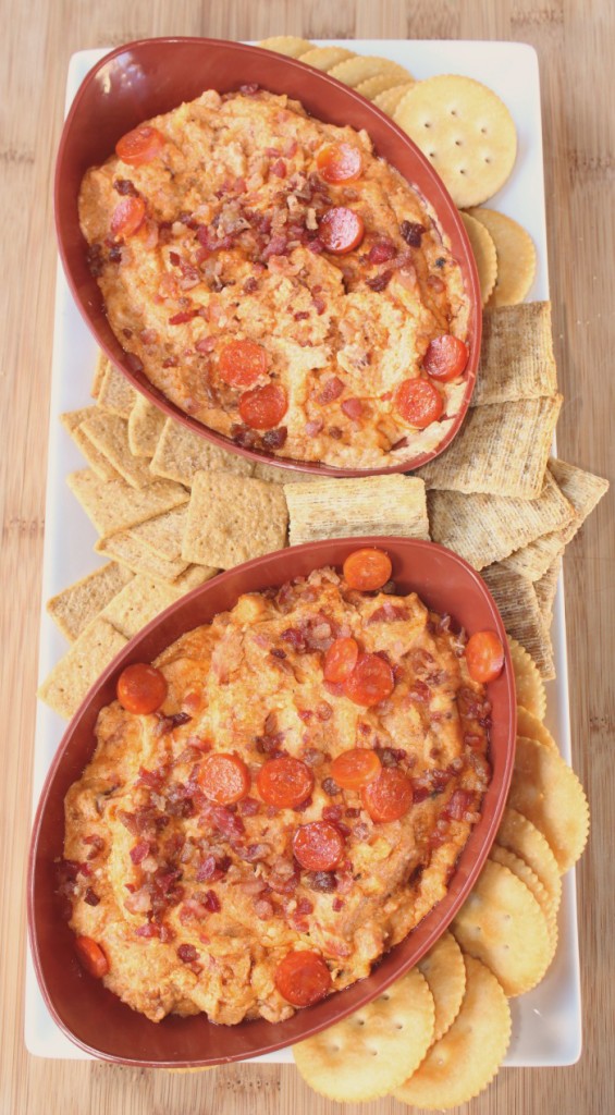 Slow Cooker Meat Lovers Dip in football bowls with crackers on a white platter