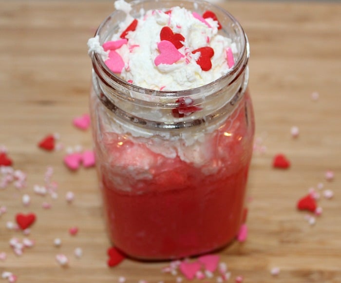 Strawberry Creamsicle Mocktail topped with whipped cream and sprinkles 