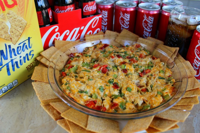 Baked Chicken Quesadilla Dip with wheat thins and coca cola cans 