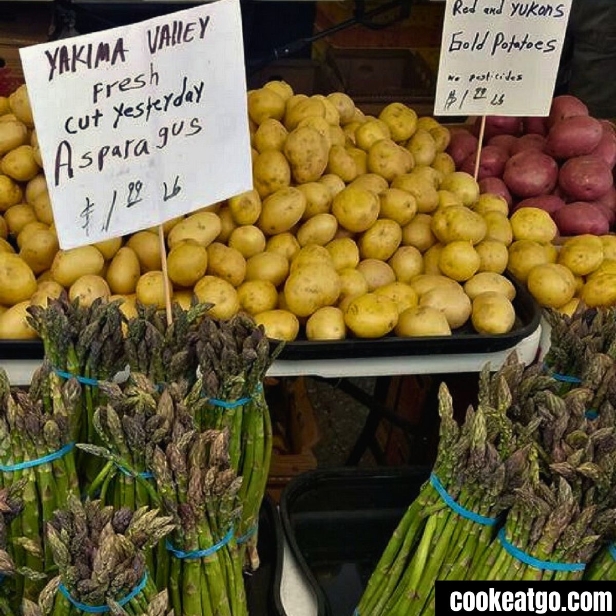 Vegetables with signs of prices at a farmers market