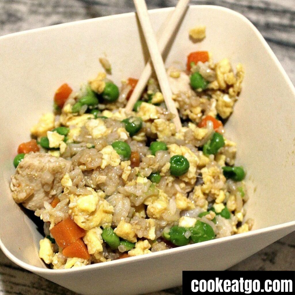 Weight watchers chicken fried rice served in a bowl with chopsticks