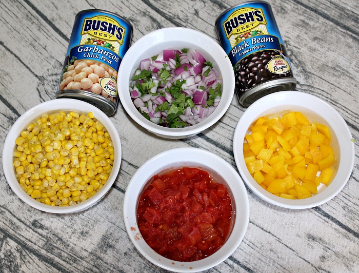 Ingredients for Cowboy Caviar On Tablecloth In White Bowls And Cans