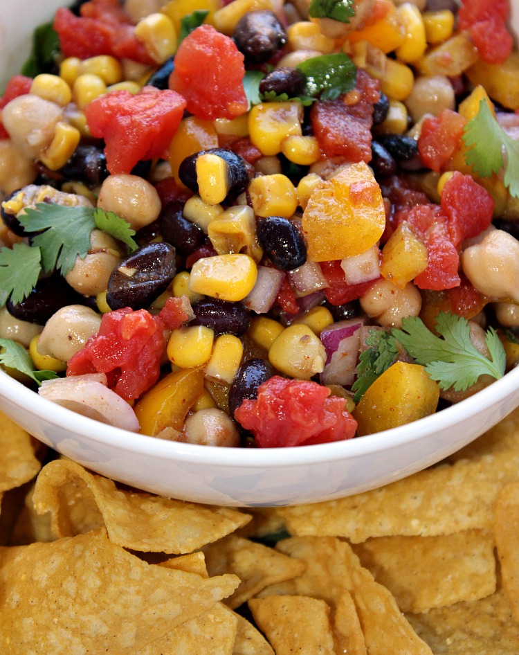 Cowboy Caviar In A White Bowl With Tortilla Chips Around The Bowl