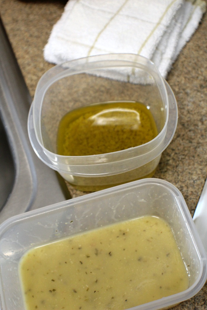 Containers with olive oil and salad dressing in them 
