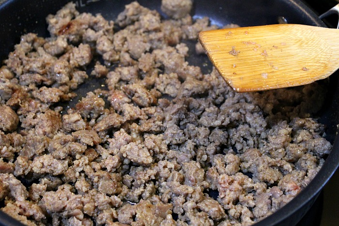 Sausage cooking in frying pan  
