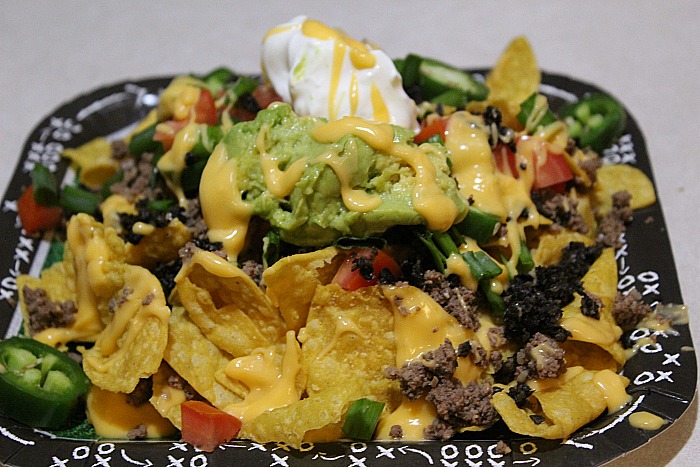 Paper plate with beef nachos on it