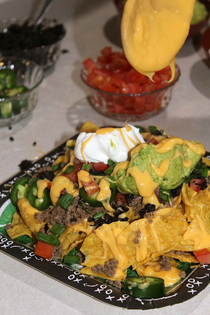A DIY Nacho Bar is the perfect way to have an easy time tailgating for any game! Plus this also makes for a laid back way to serve as well, since every one makes what they want and can just snack later on. 