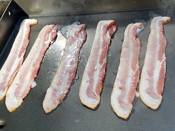 Bacon cooking on blackstone griddle