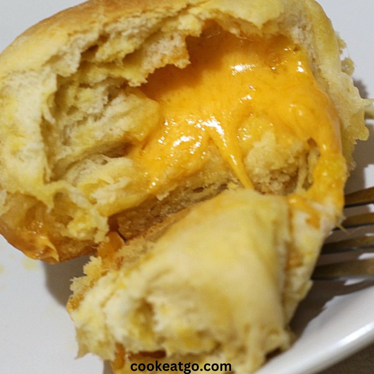 Grilled Cheese Biscuit Bite Cut Into With cheese coming out