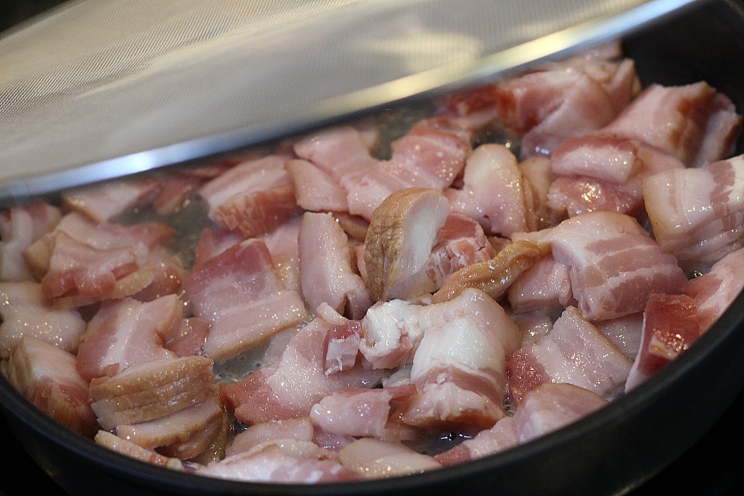 Bacon Cooking In A Fry Pan With Bacon Screen 