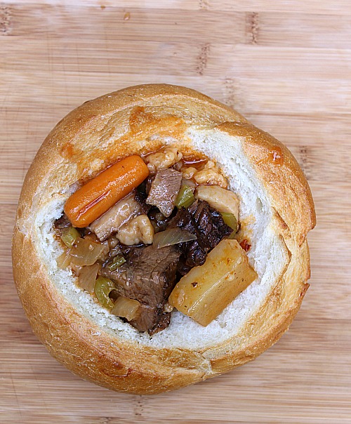 This Crockpot Brisket Stew Recipe is the perfect way to use up leftover smoked brisket! Allow to slow cook and serve in a bread bowl for a tasty dinner. 