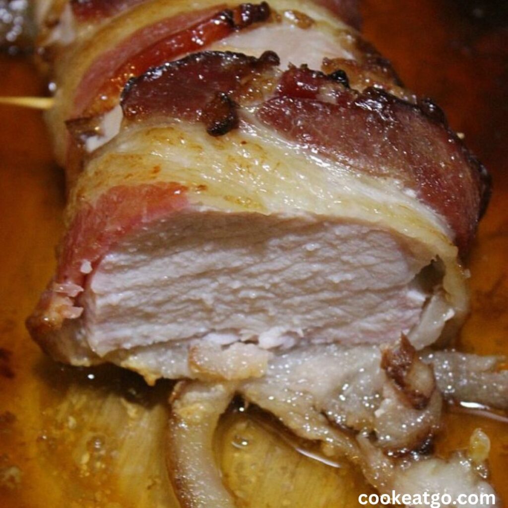 Cooked Bacon Wrapped Pork Tenderloins Sliced open 