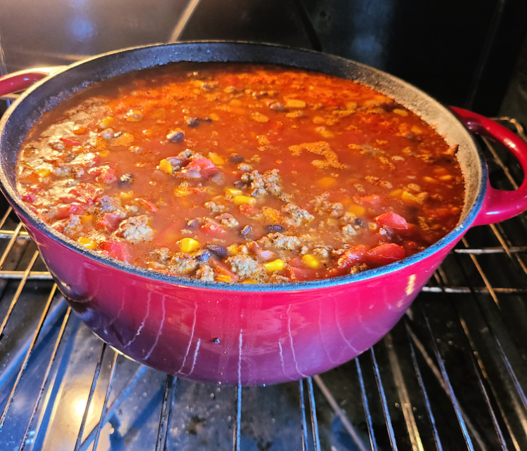 This Dutch oven Beef Chili is a huge hit with the whole family!! Just dump everything in and cook on low for a cozy comfort dinner. Easy to change up the spices and also will warm up the house with the smell of this amazing comfort food dinner! 