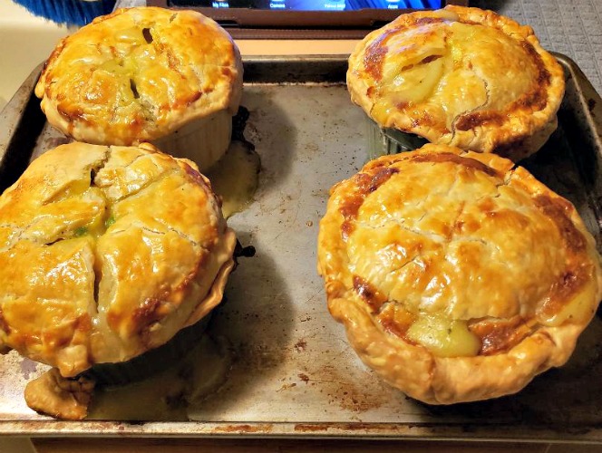 Individual Baked Chicken Pot Pies on a cookie sheet
