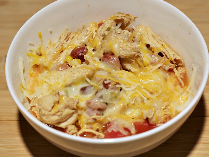Weight Watchers Chicken Taco Soup in a white bowl topped with three cheese 