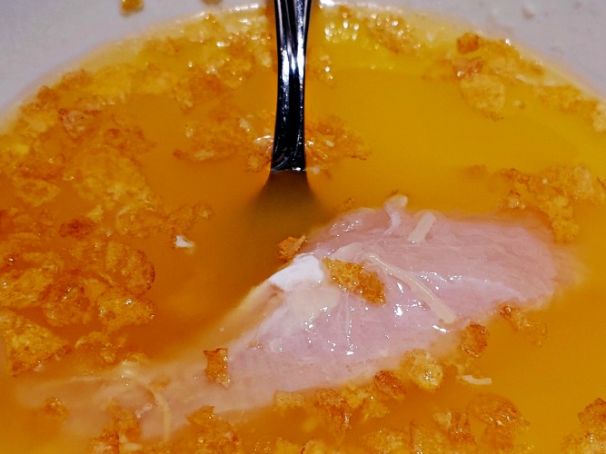 Chicken Tender Being Coated in melted Butter