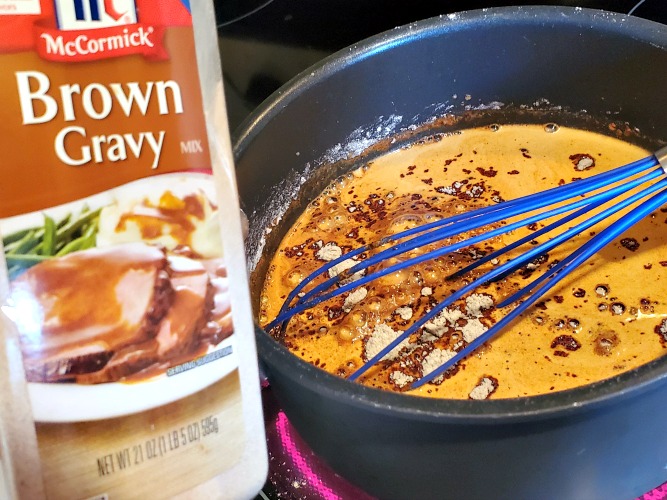 McCormick Brown Gravy with sauce pan in back ground 
