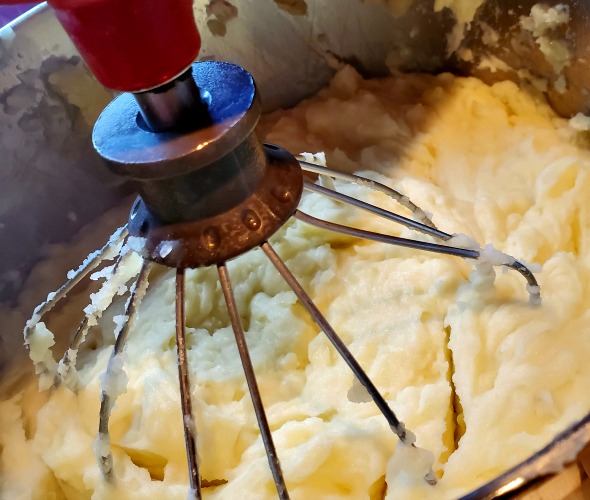 Mashed potatoes being mixed in kitchen aid mixer 