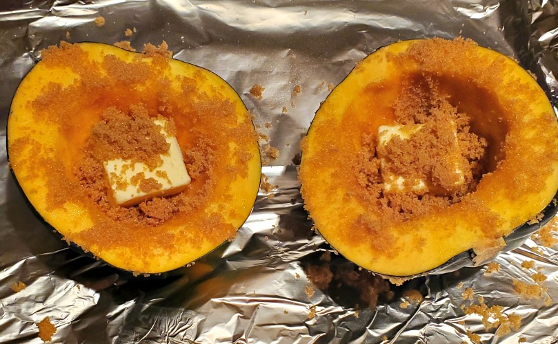 Acorn Squash With Butter And Brown Sugar On The Cut Halves on Foil 