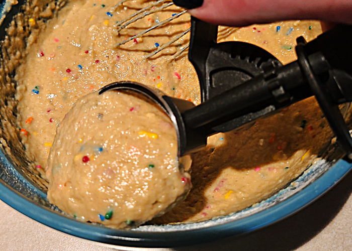 Scooping Sprinkle WW Kodiak Muffins out of a bowl