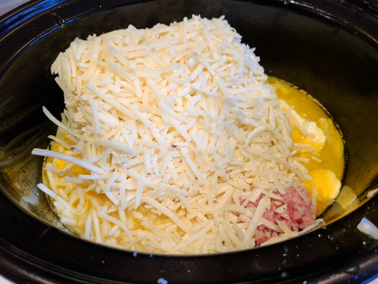 Crockpot With Broth, Cheese, Cream Cheese, shredded hashbrowns, ham, And Butter in it for Cheese Broccoli Potato Soup