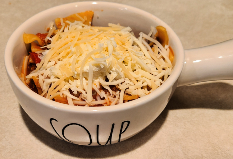 Cooked Lasagna Soup in bowl topped with cheeses!  