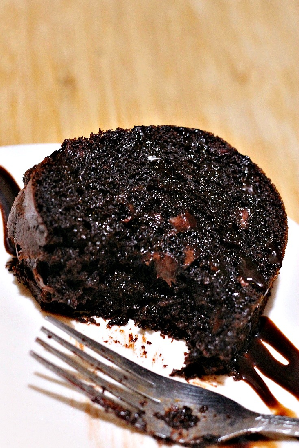 Sliced Chocolate Bundt Cake on a white plate with a fork