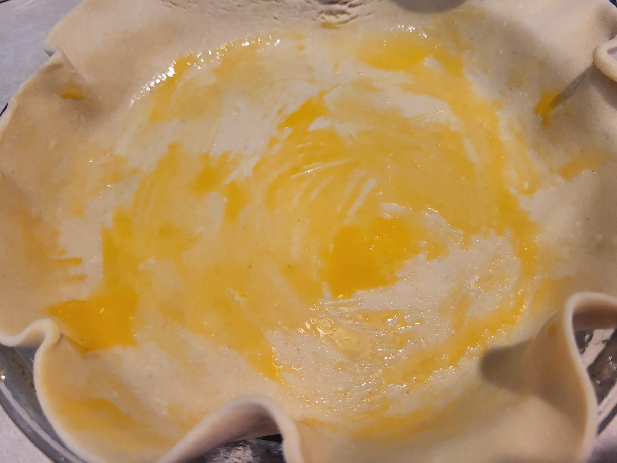 Store Bought Pie crust with egg wash in pie pan 
