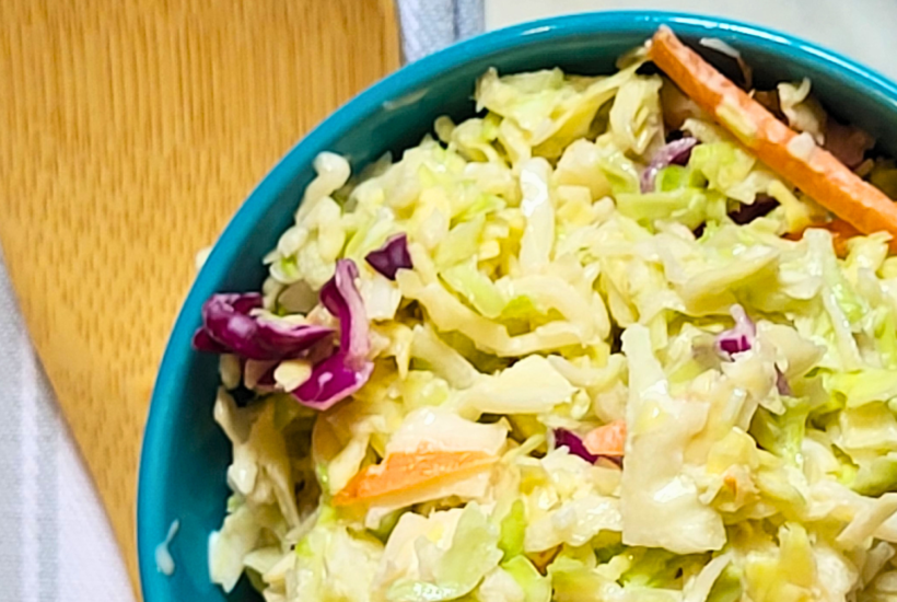 4 Ingredient Coleslaw in a bowl with a wooden spoon next to it
