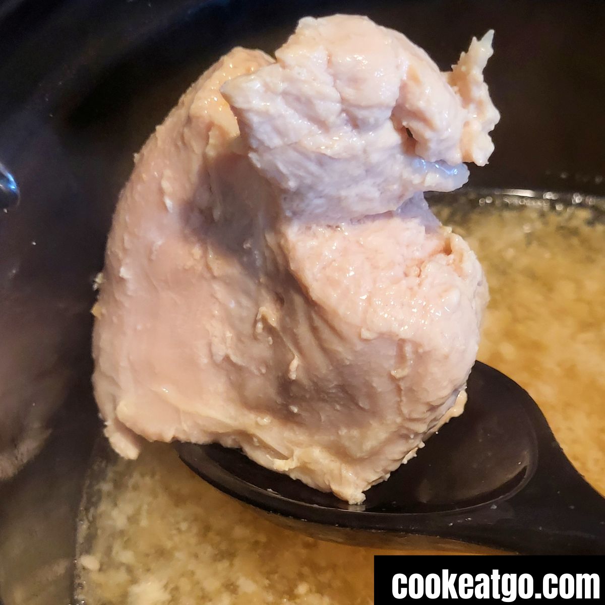 Cooked turkey Breast in crockpot of broth