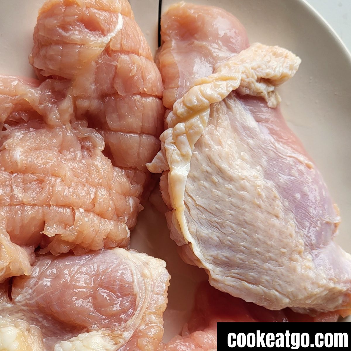 Uncooked chunks of turkey breasts on a plate