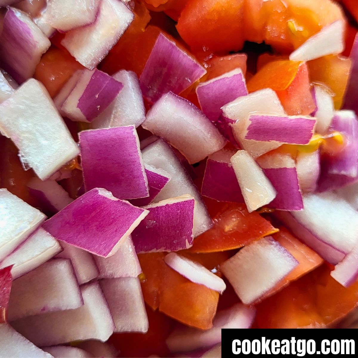 Diced red Onion and tomato for cucumber salad in a bowl