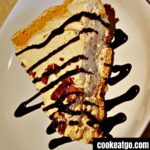 Peanut Butter Pie Served on a plate drizzled with chocolate syrup