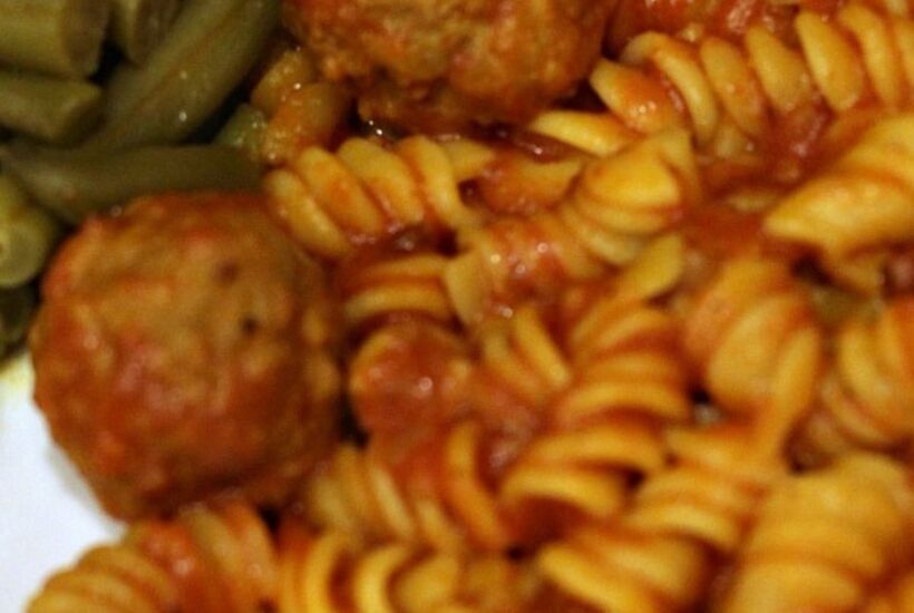 Instant pot meatballs and pasta served with green beans and garlic bread