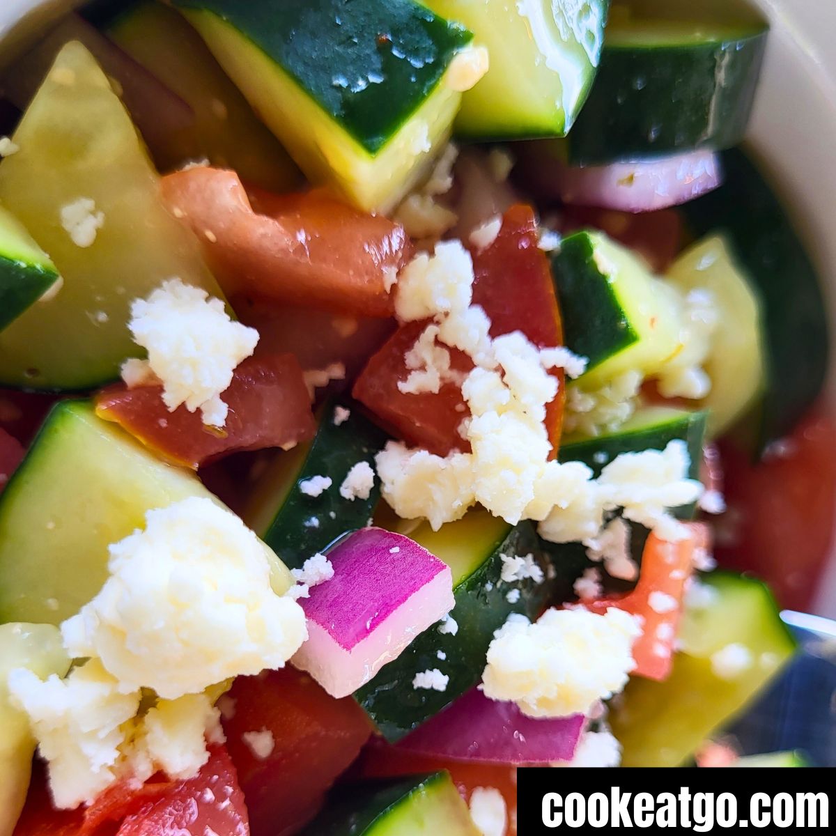 Italian Tomato & Cucumber Salad topped with feta cheese