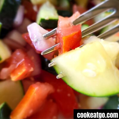 Italian Tomato and Cucmber Salad on a fork