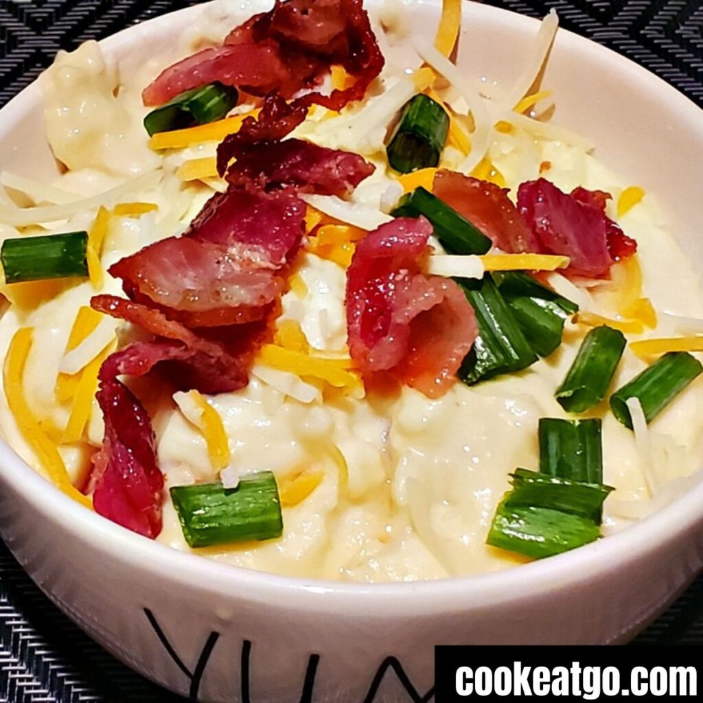 Loaded mashed potatoes served in a white bowl