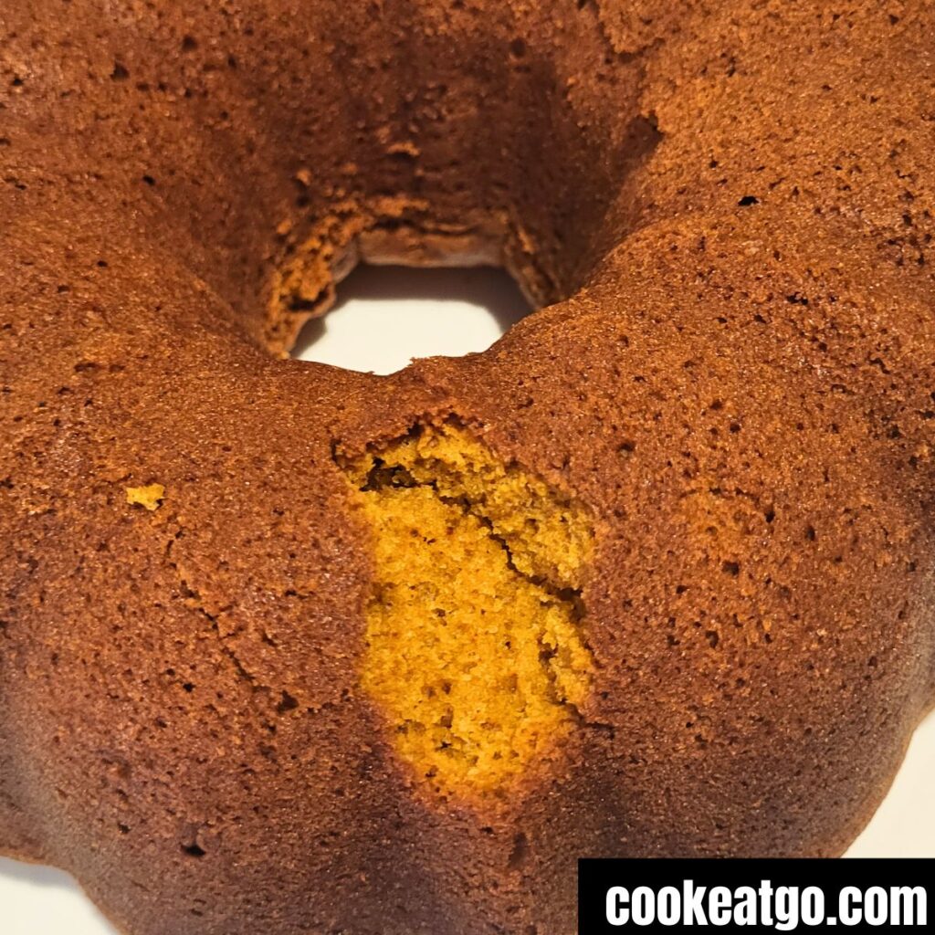 Pumpkin bundt cake with a chunk missing from the flipping process