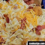 popcorn chicken pasta salad served garnished with shredded cheese and bacon