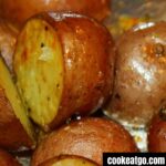 Oven roasted garlic potatoes cooked on a cookie sheet covered in tin foil