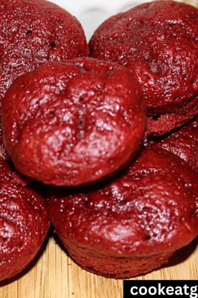 Red Velvet Weight Watchers Muffins in a white bowl with a pile of muffins around it.